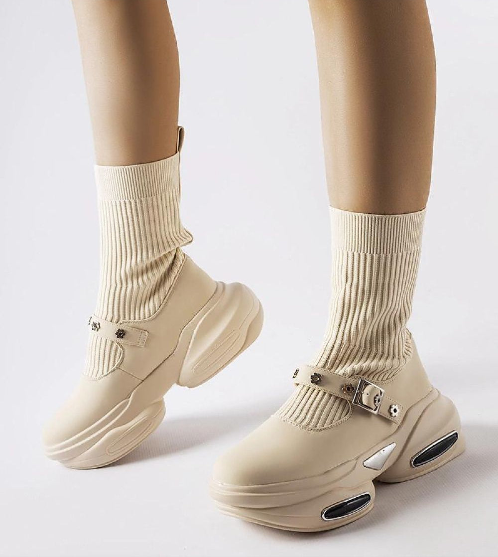Beige stretch knit ankle boots with thick sole and ribbed sock-like shaft, featuring a modern design and comfortable fit.