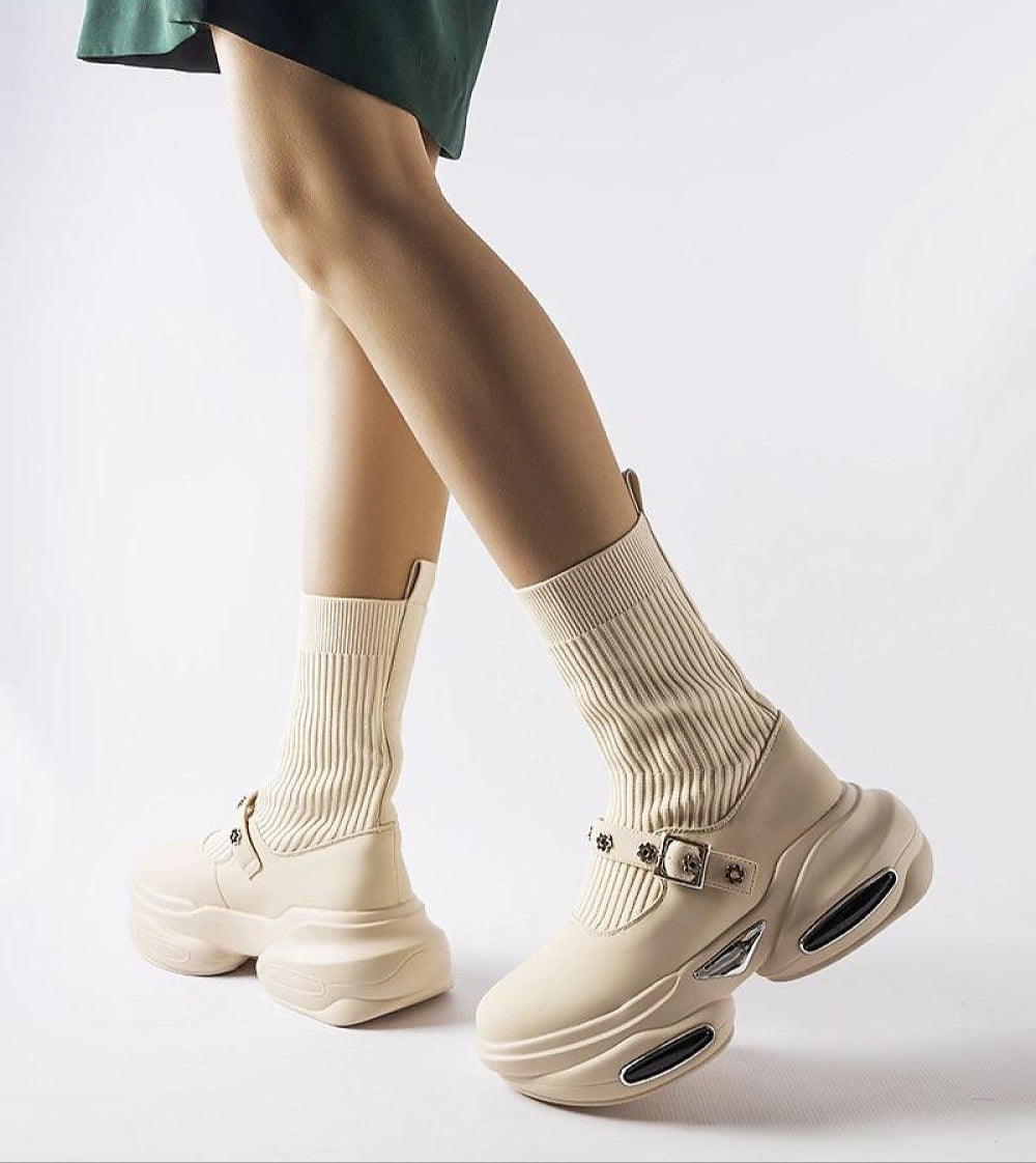 Elvessa beige stretch knit ankle boots with sculpted heel and sock-like shaft for modern style and comfort.