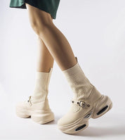 Elvessa beige stretch knit ankle boots with sculpted heel and sock-like shaft for modern style and comfort.