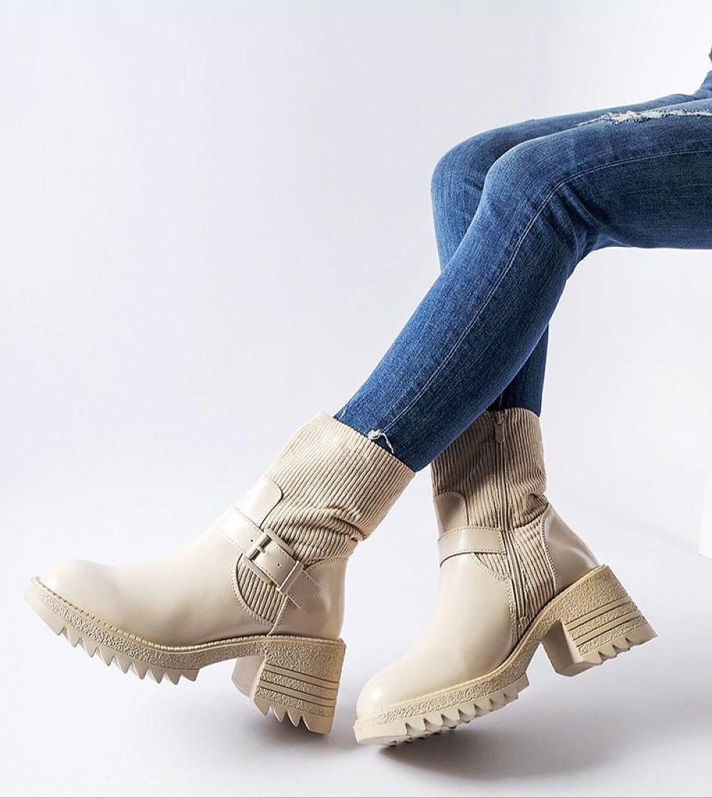 Woman wearing Maressa Insulated Ankle Boots in beige eco leather, styled with blue jeans, showcasing the high ankle cut and block heel.