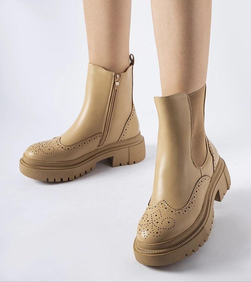 Beige Castressa stitched ankle boots with sculpted silhouette and elastic panels, featuring a discreet zipper and rounded toe on a white background.