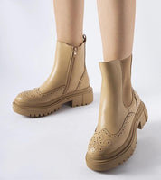 Beige Castressa stitched ankle boots with sculpted silhouette and elastic panels, featuring a discreet zipper and rounded toe on a white background.