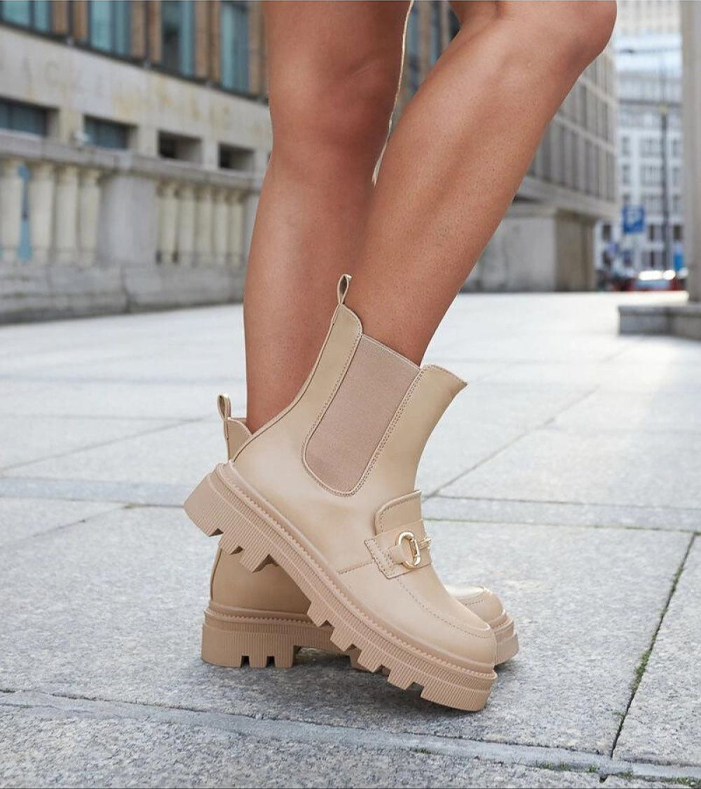 Side view of Bellantra High-Heel Zip Boots in deep beige, featuring a treaded sole, rounded toe, and full side zipper for easy wear.