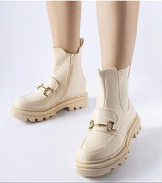 Deep beige high-heel zip boots with rounded toe and gold detailing, featuring a treaded sole for comfort and style.