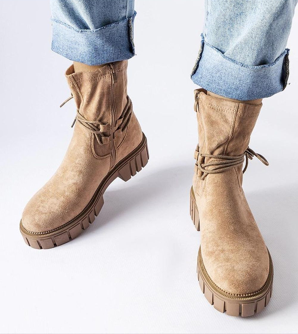 Veronea beige eco leather zipped bonded boots with laces and rubber sole on a model wearing rolled jeans, side view