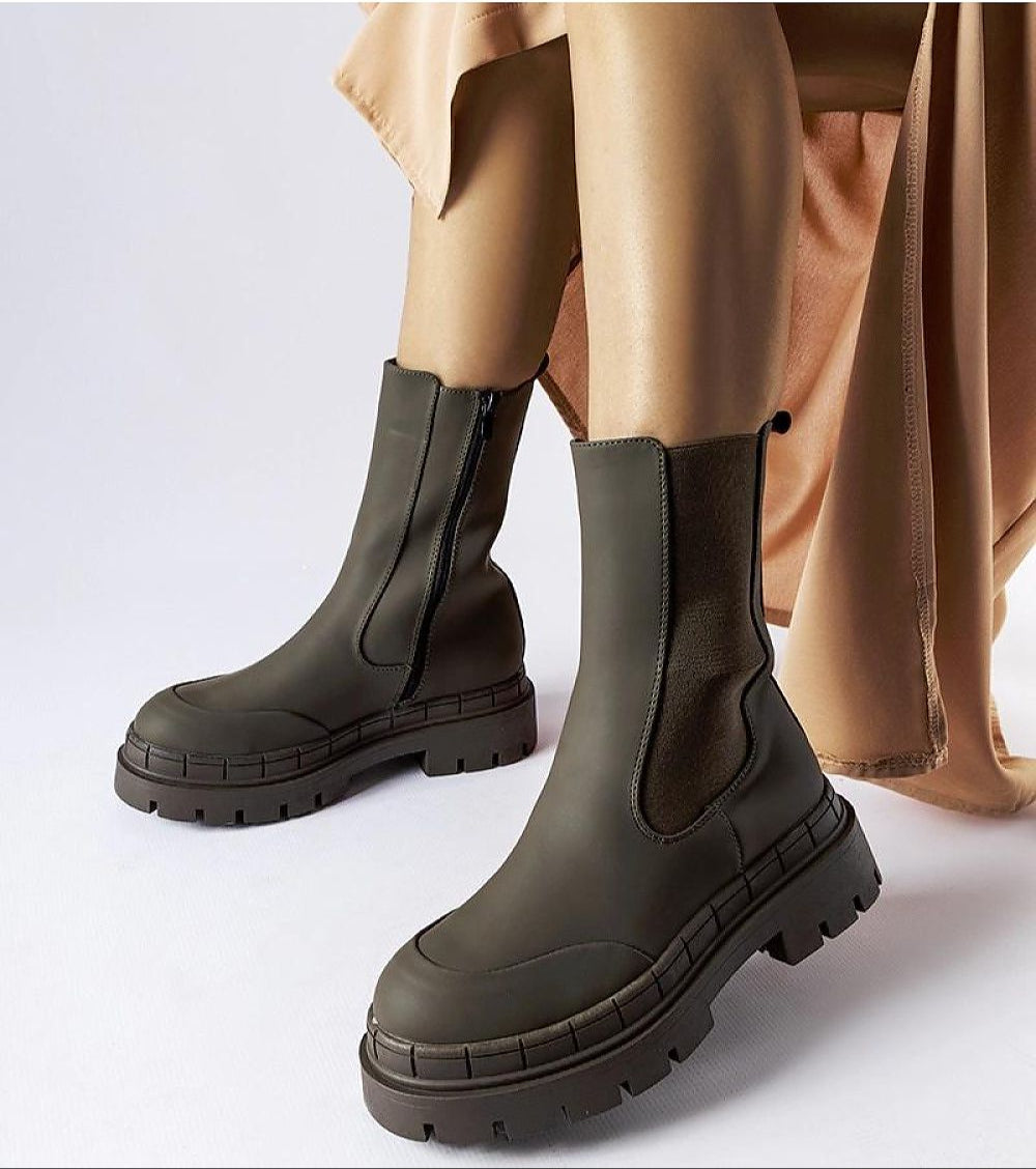 Deep green Dralyn Urban Rubber Boots with zip closure, offering a minimalist look and reliable protection for wet conditions.