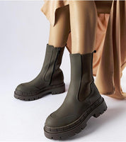 Deep green Dralyn Urban Rubber Boots with zip closure, offering a minimalist look and reliable protection for wet conditions.