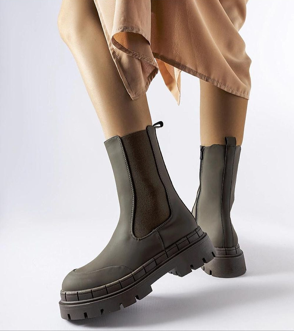 Dralyn Urban Rubber Boots in deep green with zip closure and chunky sole, worn by model in peach dress, ideal for rainy days.
