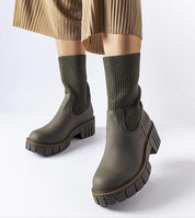 Avidra Knit Platform Boots with a green sole and stretch-knit upper, showcasing a modern ankle-high design with a chunky platform base.