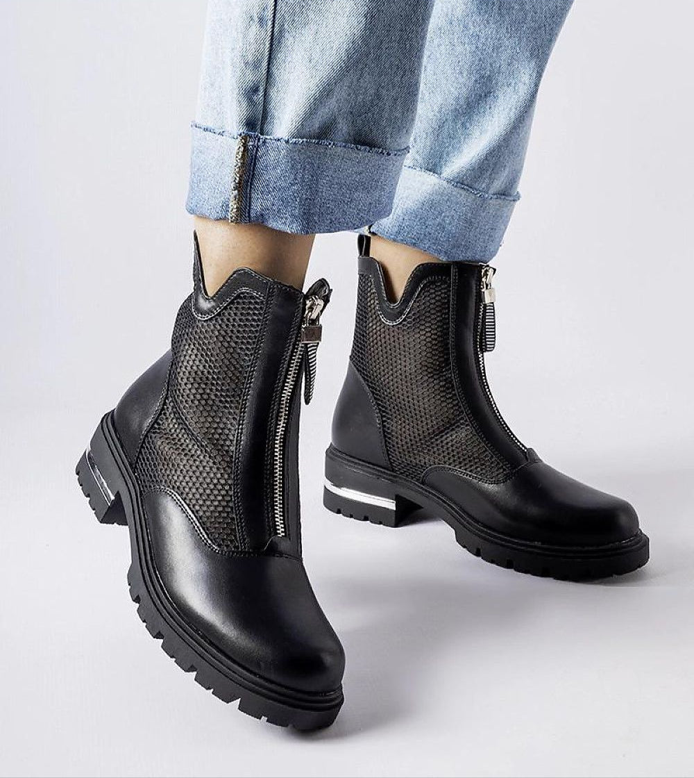 Model wearing Cavour openwork eco leather boots with side zipper and mid-height heel, paired with rolled denim jeans.