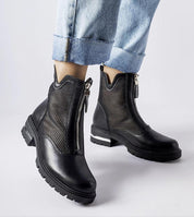 Model wearing Cavour openwork eco leather boots with side zipper and mid-height heel, paired with rolled denim jeans.