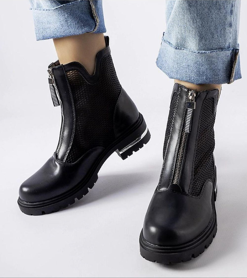 Cavour openwork eco leather boots with side zippers, combining modern elegance and comfort, worn with cuffed jeans.