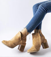 Woman wearing Artemisia Eco Leather Heel Boots with side cutouts, 8 cm heel, and contrasting beige sole, styled with frayed jeans.