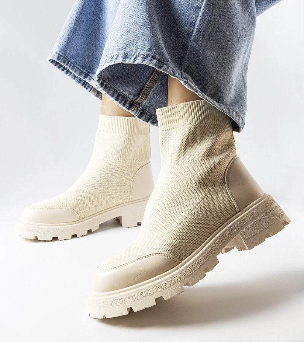 Beige Lonte Stretch-Knit Sock Boots with medium heel and rounded toe, paired with jeans.