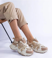 Avessia Elevated Suede Accent Sneakers with shimmering inserts, beige pants, and a 6 cm platform, perfect for casual outfits.