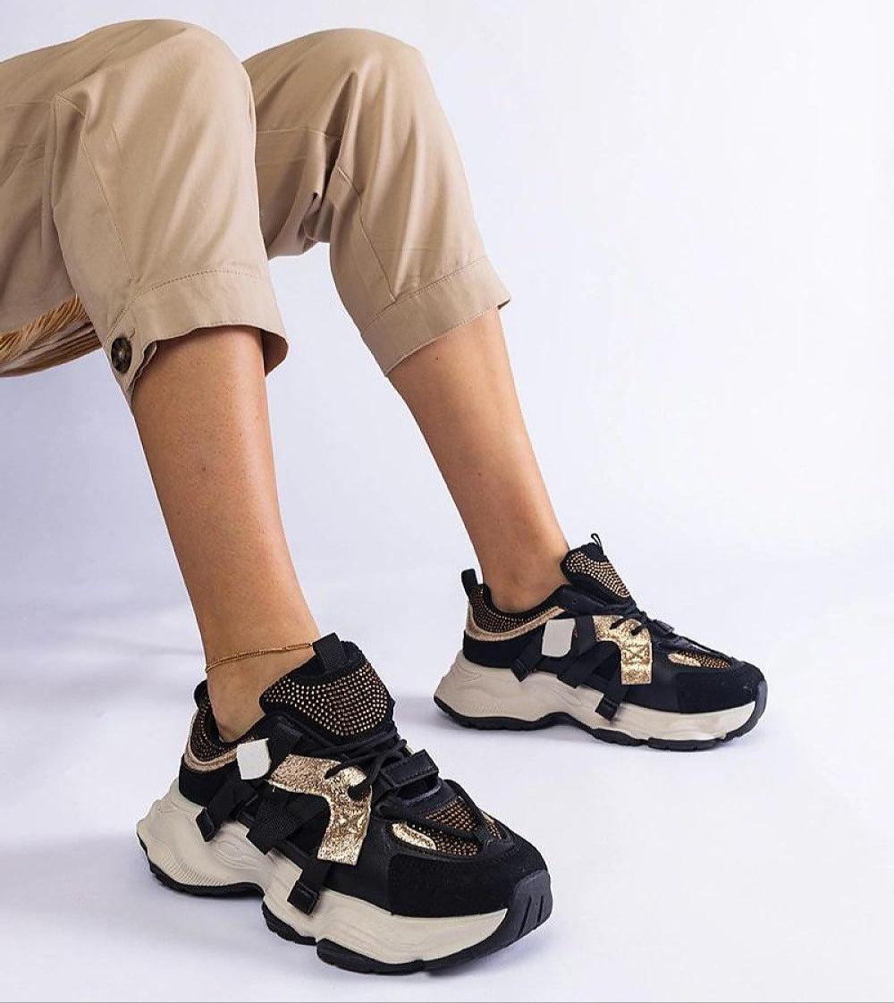 Woman wearing Avessia Elevated Suede Accent Sneakers with a 6 cm platform, featuring black eco suede and shimmering inserts.