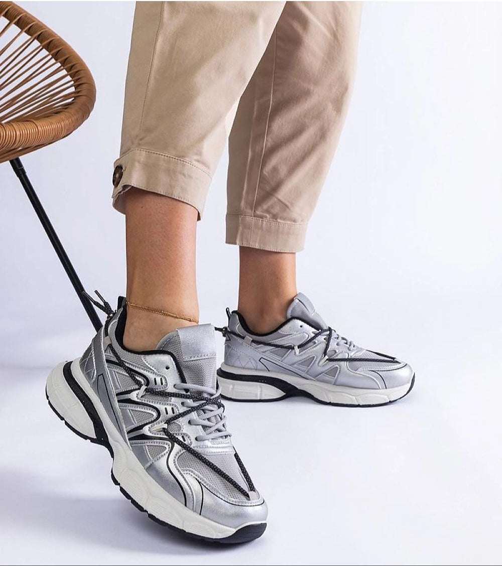 Person wearing Yndessa Sculpted Sole Lace Sneakers with beige pants, showcasing modern design and eco leather material.