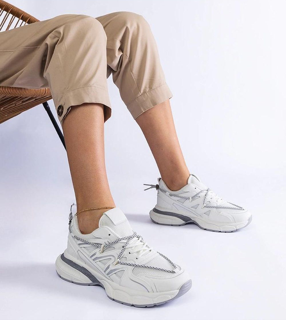 Woman wearing Yndessa Sculpted Sole Lace Sneakers, showcasing sleek design and eco-leather craftsmanship on a sculpted sole.