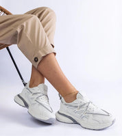 Person wearing Yndessa Sculpted Sole Lace Sneakers in white with eco leather design, showcasing sleek structure and versatility.