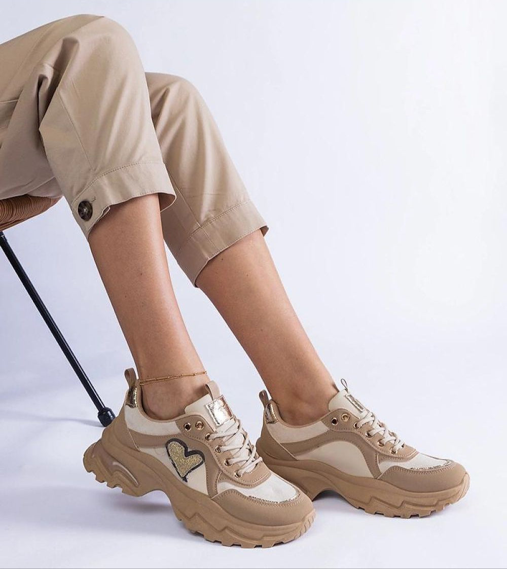 Orevia heart-detailed brown sneakers with platform and eco leather, featuring a heart accent, worn by model in beige pants.