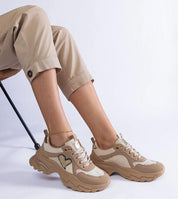 Orevia heart-detailed brown sneakers with platform and eco leather, featuring a heart accent, worn by model in beige pants.