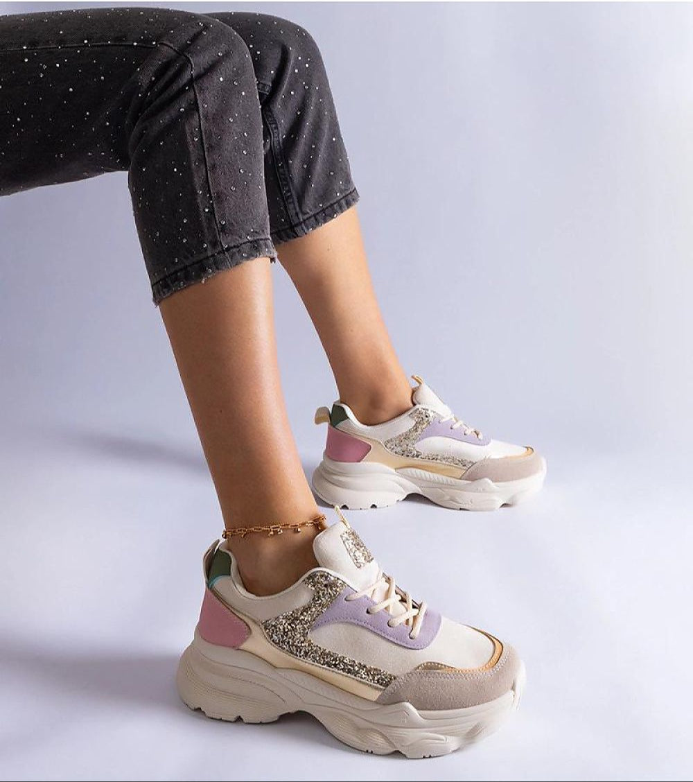 Elyvanna Brocade Panel Suede Sneakers with beige suede and shimmering brocade accents on person wearing them, featuring thick white sole.