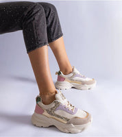 Elyvanna Brocade Panel Suede Sneakers with beige suede and shimmering brocade accents on person wearing them, featuring thick white sole.