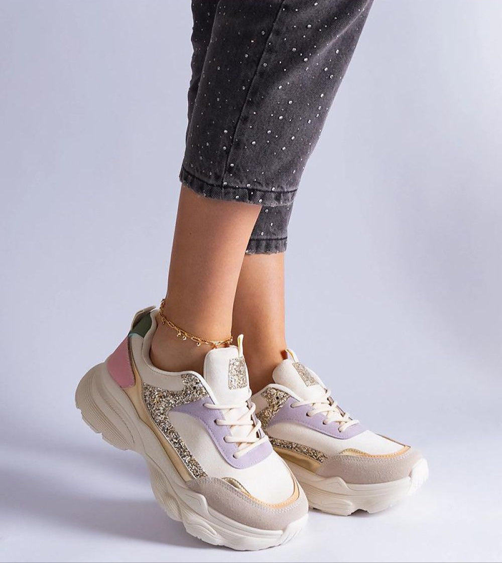 Elyvanna Brocade Panel Suede Sneakers with glittering accents and white rubber sole, worn with cropped jeans.