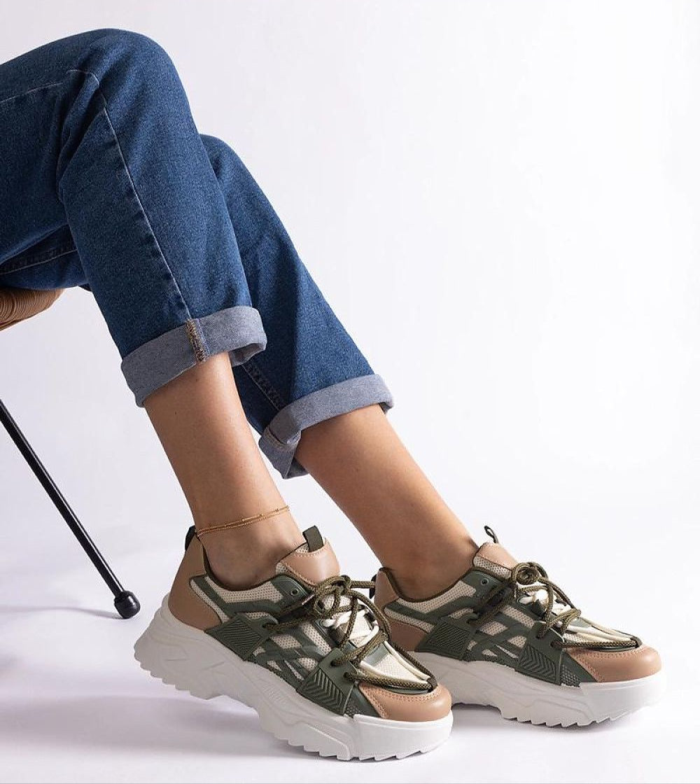Person wearing Orlira Sage-Toned Urban Sneakers with green and beige tones, showcasing a 5 cm rubber sole and lace-up design.