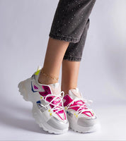 Woman wearing colorful sport sneakers with black jeans, showcasing trendy athletic footwear style.