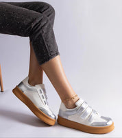 Person wearing Elurea Gold Velcro Street Sneakers with brown soles, showcasing eco leather and stylish low-top design.