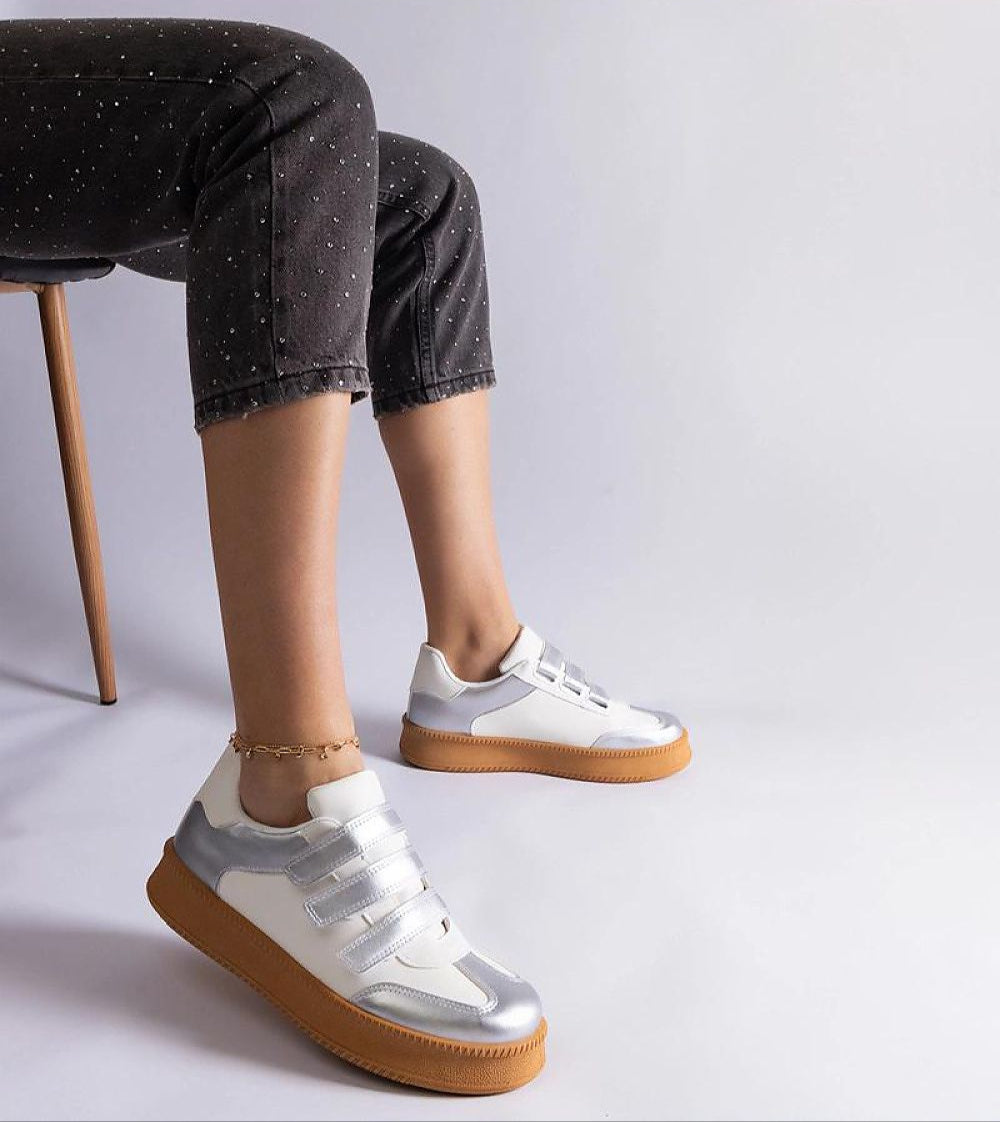 Person wearing Elurea Gold Velcro Street Sneakers with eco leather and brown rubber sole sitting on a chair.