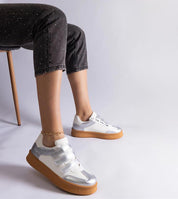 Person wearing Elurea Gold Velcro Street Sneakers with eco leather and brown rubber sole sitting on a chair.