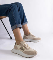 Person wearing Veressa Minimal Platform Sneakers with beige rubber platform and low-cut design, pairing with rolled-up jeans.