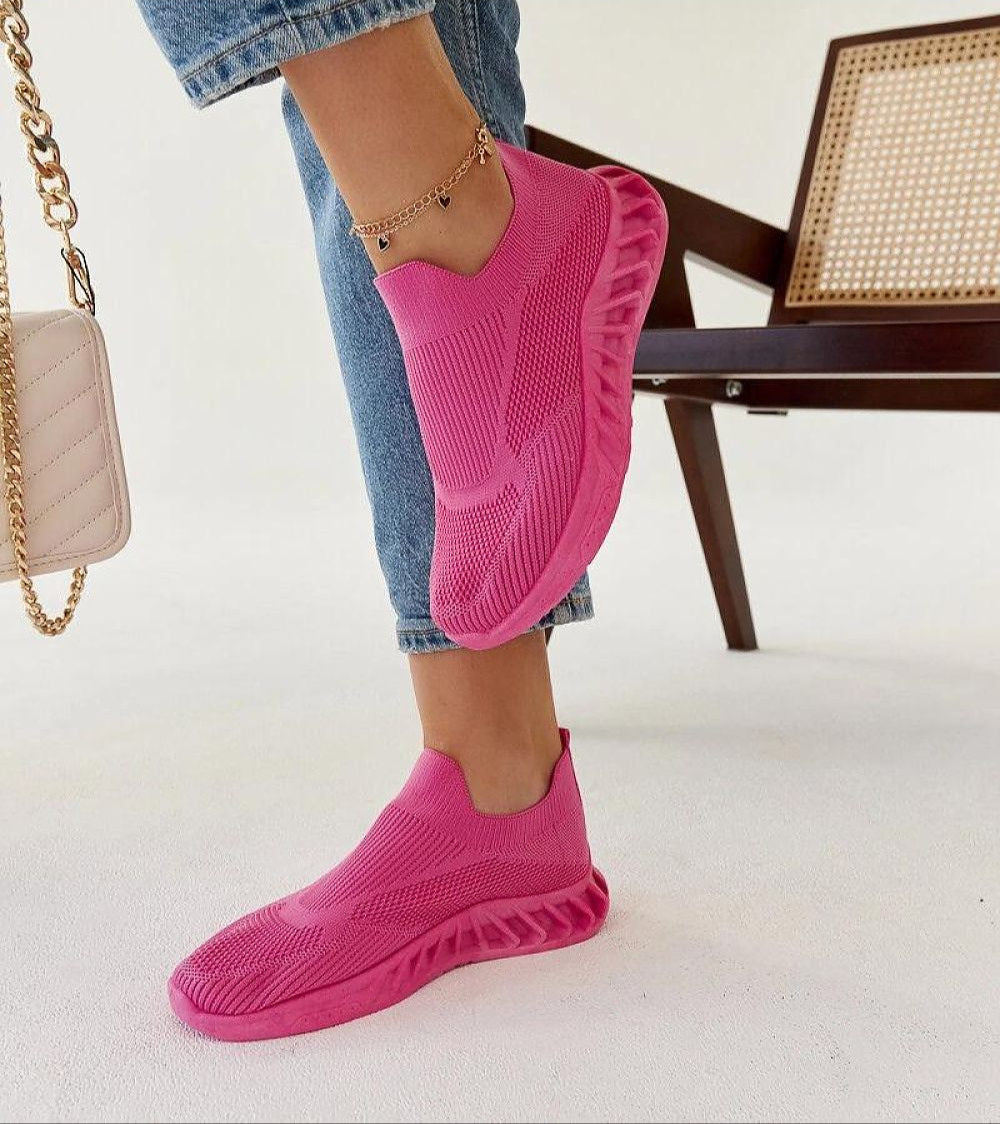Person wearing pink Zavella Slip-On Sport Knit Sneakers with a flexible, breathable design, ideal for active summer wear.