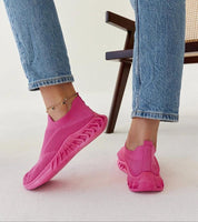 Person wearing pink Zavella Slip-On Sport Knit Sneakers with jeans, showcasing breathable textile upper and flexible design.