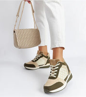 Stylish ankle-high sneakers in beige and olive tones paired with white pants and a beige quilted handbag, showcasing a trendy casual look.
