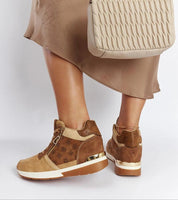 Woman wearing Valterra Brown Wedge Sneakers with an 8 cm heel, pairing them with a beige dress and matching textured bag.
