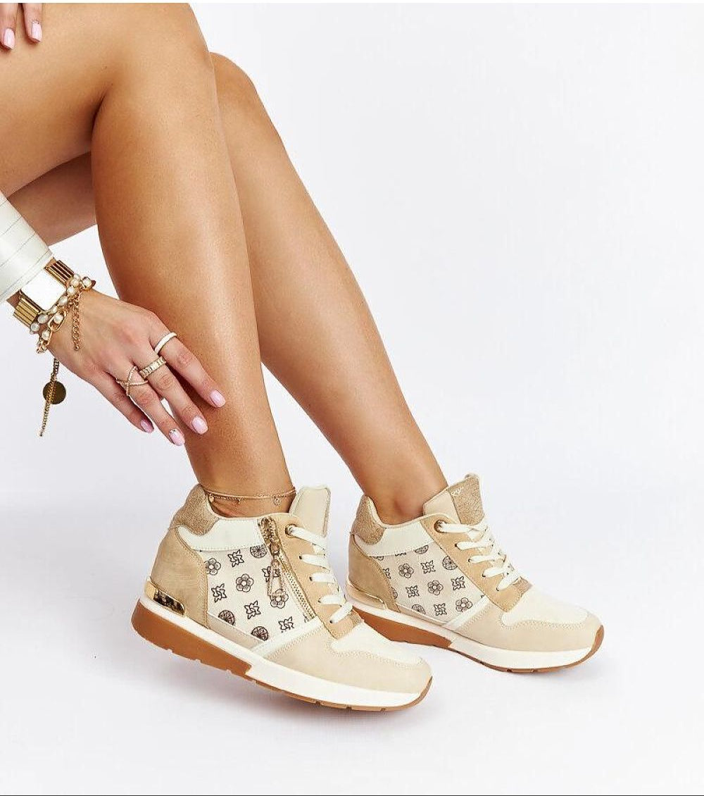 Stylish high-top beige sneakers with lace-up closure paired with gold bracelets, showcasing a chic casual look.