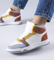 Colorful Aurelyth suede-touch ankle sneakers with eco leather, lace-up closure, worn with jeans on gray background.