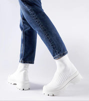 Person wearing Velvone slip-on platform sneakers in white with blue jeans for casual spring style.