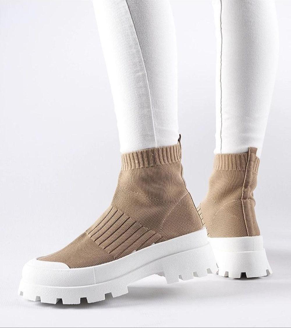 Woman wearing Velvone Slip-On Platform Sneakers in beige with white elevated sole, showcasing modern casual style and comfort.