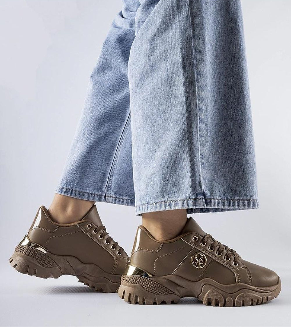 Arpaia chunky brown eco leather sneakers for women with thick rubber sole and classic lacing paired with casual denim jeans.