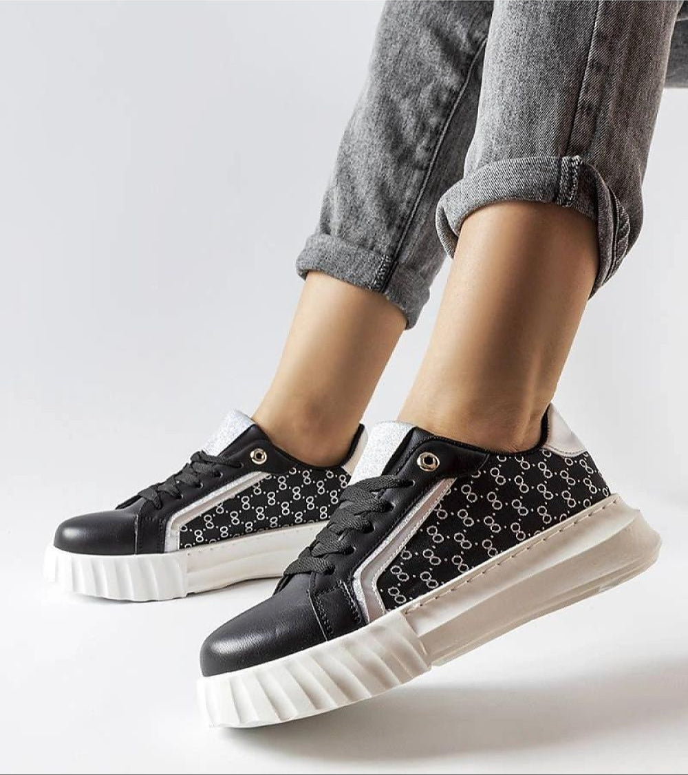 Person wearing Varello Urban Platform Sneakers in Black with white sole, showcasing streetwear style and eco-friendly design.