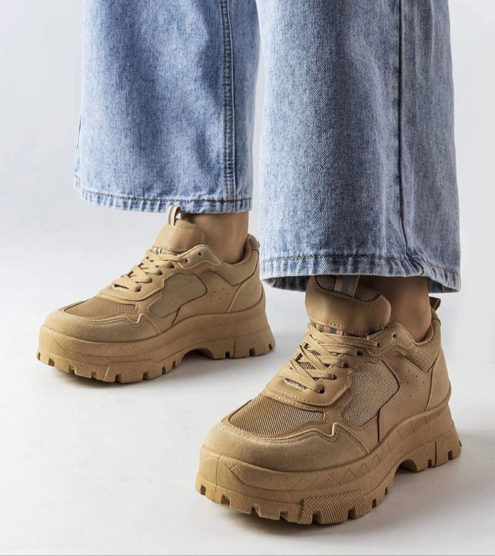 Woman wearing Avenza Beige Sporty Lace-Up Sneakers for Women, featuring breathable material and a tone-on-tone rubber sole for comfort.