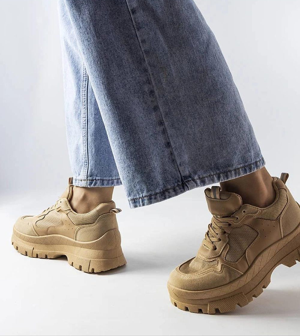 Avenza beige sporty lace-up sneakers for women, featuring a comfortable design with tone-on-tone rubber sole, paired with blue jeans.