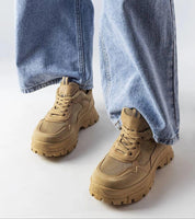 Avenza beige sporty lace-up sneakers for women with jeans, featuring breathable materials and a tone-on-tone rubber sole for comfort.