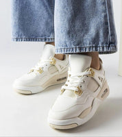 Model wearing Argena Beige Low-Top Summer Sneakers with denim jeans, showcasing the breathable design and white rubber sole for traction.