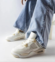 Person wearing Argena Beige Low-Top Summer Sneakers with light blue jeans, featuring breathable materials and white rubber sole.