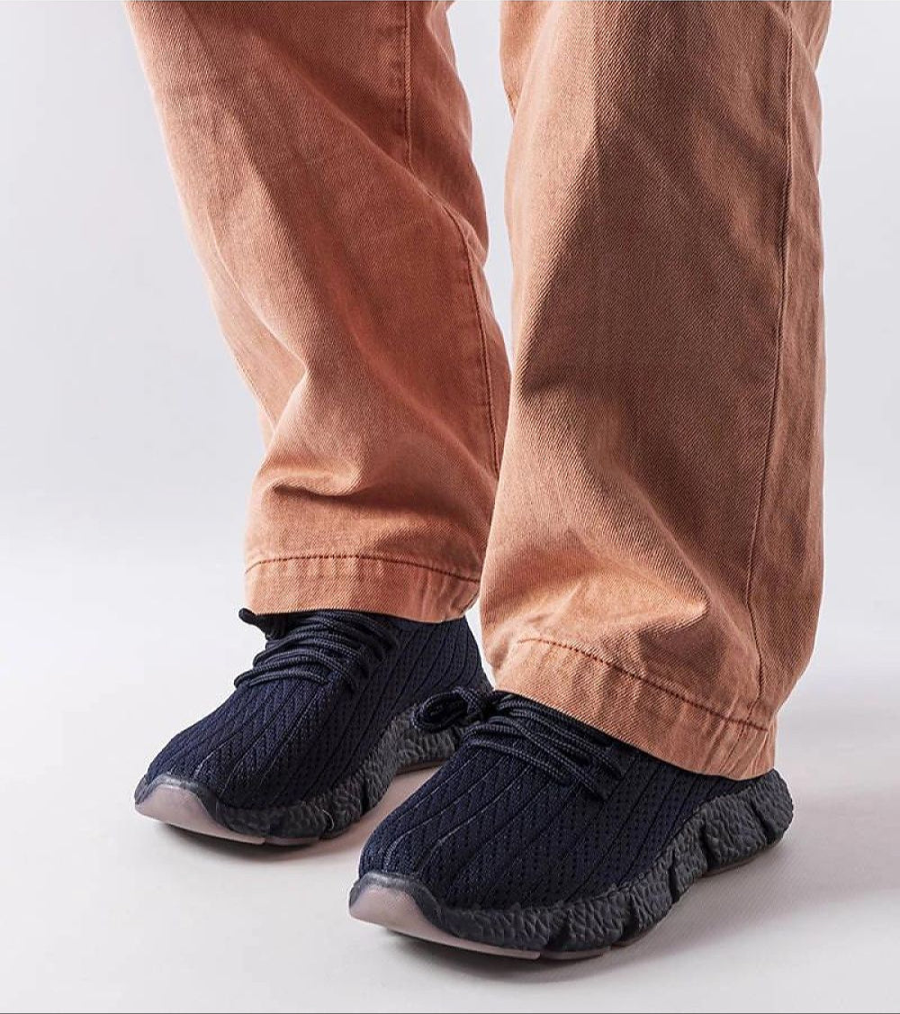 Person wearing Arvène navy summer sport sneakers with round toe and lace-up design, showcasing breathable textile and lightweight comfort.